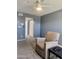 Comfortable living room featuring a plush armchair, neutral carpet, and a ceiling fan for a cozy and inviting space at 8302 N 21St Dr # L204, Phoenix, AZ 85021