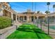 Expansive backyard with a lush lawn, covered patio, and beautiful landscaping at 8712 N 64Th Pl, Paradise Valley, AZ 85253
