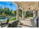 Relaxing covered patio featuring stone columns, ceiling fans and views of the backyard and pool at 8712 N 64Th Pl, Paradise Valley, AZ 85253