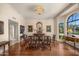 Elegant dining room with hardwood floors, custom molding, designer lighting, and natural light at 8712 N 64Th Pl, Paradise Valley, AZ 85253