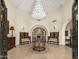 Grand foyer showcasing soaring ceilings, travertine floors, custom woodwork and designer lighting at 8712 N 64Th Pl, Paradise Valley, AZ 85253