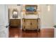 Hallway featuring hardwood floors, decorative sconces, and ornate painted cabinets at 8712 N 64Th Pl, Paradise Valley, AZ 85253