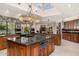 Spacious kitchen featuring granite counters, custom cabinets, travertine floors and large center island at 8712 N 64Th Pl, Paradise Valley, AZ 85253