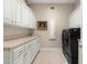 Functional laundry room featuring ample cabinetry, counter space and modern appliances at 8712 N 64Th Pl, Paradise Valley, AZ 85253