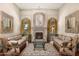 Cozy living room with fireplace, plush seating, custom drapes, wood floors and natural light at 8712 N 64Th Pl, Paradise Valley, AZ 85253