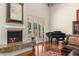 Bright living room with fireplace, grand piano, and backyard access at 8712 N 64Th Pl, Paradise Valley, AZ 85253