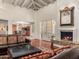 Open-concept living room with fireplace and view into kitchen and backyard at 8712 N 64Th Pl, Paradise Valley, AZ 85253