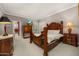 Bedroom showcases a carved wood bed, carpet flooring, and an attached ensuite at 8712 N 64Th Pl, Paradise Valley, AZ 85253