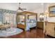 Elegant main bedroom with hardwood floors, canopy bed, and custom drapery at 8712 N 64Th Pl, Paradise Valley, AZ 85253
