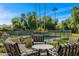 Inviting patio area with comfortable seating overlooking a sparkling pool and lush landscape at 8712 N 64Th Pl, Paradise Valley, AZ 85253