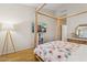 Bright bedroom featuring light hardwood floors and wooden four-poster bed frame at 1024 E Frye Rd # 1063, Phoenix, AZ 85048