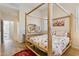 Inviting bedroom with wooden four-poster bed, light floors and natural light at 1024 E Frye Rd # 1063, Phoenix, AZ 85048
