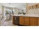 Bright open kitchen with tile floors, natural wood cabinets, and stainless steel dishwasher at 1024 E Frye Rd # 1063, Phoenix, AZ 85048