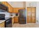 Bright kitchen with modern appliances, tile floors, neutral walls, and natural wood cabinets at 1024 E Frye Rd # 1063, Phoenix, AZ 85048