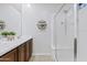 Bright bathroom with a shower and dual sink vanity, complemented by modern shelving at 1051 W Inca St, Mesa, AZ 85201