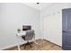 This bedroom features wood flooring, a ceiling fan, a closet, and a desk, offering a great space at 1051 W Inca St, Mesa, AZ 85201