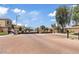 Gated community entrance with brick-paved road and stone pillars on a sunny day at 1051 W Inca St, Mesa, AZ 85201