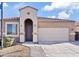 Charming single-story home with desert landscaping, arched entryway, and a two car garage at 1051 W Inca St, Mesa, AZ 85201