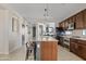 Kitchen island with granite countertop, stainless appliances, and breakfast bar seating at 1051 W Inca St, Mesa, AZ 85201