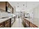 Modern kitchen featuring granite countertops, stainless steel appliances, and dark wood cabinets at 1051 W Inca St, Mesa, AZ 85201