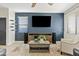 Comfortable living room features a sleek entertainment center, modern furniture and a wall with blue paint at 1051 W Inca St, Mesa, AZ 85201