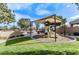 Community playground with slide and covered area with benches surrounded by grass and landscaping at 1051 W Inca St, Mesa, AZ 85201