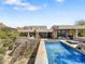 A modern home features a sleek pool and landscaped backyard creating an inviting outdoor space at 10801 E Happy Valley Rd # 4, Scottsdale, AZ 85255