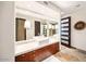 Contemporary bathroom with stone floors, vessel sink, modern cabinets, and oversized mirror at 10801 E Happy Valley Rd # 4, Scottsdale, AZ 85255