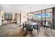 Modern dining room area with large windows, stone accents and an adjacent billiard room at 10801 E Happy Valley Rd # 4, Scottsdale, AZ 85255