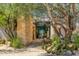 Inviting entrance features stone accents, mature landscaping, and a glimpse of the luxurious interior at 10801 E Happy Valley Rd # 4, Scottsdale, AZ 85255