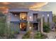 Stunning modern home with stone accents, desert landscaping, and a beautiful sunset backdrop at 10801 E Happy Valley Rd # 4, Scottsdale, AZ 85255