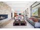 Cozy living room offers stone fireplace, high ceilings, and expansive windows offering stunning views at 10801 E Happy Valley Rd # 4, Scottsdale, AZ 85255