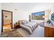 Comfortable bedroom featuring ample natural light, stone floors, and neutral colors at 10801 E Happy Valley Rd # 4, Scottsdale, AZ 85255