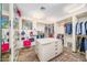Spacious walk-in closet with custom shelving, center island, and natural light at 10801 E Happy Valley Rd # 4, Scottsdale, AZ 85255