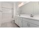 Clean, bright bathroom featuring double sinks, white cabinets, and a shower-tub combo at 12029 W Marguerite Ave, Avondale, AZ 85323