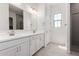 Bright bathroom featuring double sinks, white cabinets, and modern fixtures at 12029 W Marguerite Ave, Avondale, AZ 85323