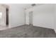 This is a spacious bedroom with plush gray carpet and a door leading to the bathroom at 12029 W Marguerite Ave, Avondale, AZ 85323