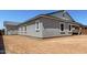 Exterior view of the home featuring white trim, gray stucco, and a new roof at 12029 W Marguerite Ave, Avondale, AZ 85323