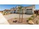 Well-maintained single-Gathering home featuring a two-car garage, brick driveway, and desert landscaping at 12029 W Marguerite Ave, Avondale, AZ 85323