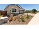 Attractive single-Gathering house showing stone accents, a two-car garage, and desert landscaping in front yard at 12029 W Marguerite Ave, Avondale, AZ 85323
