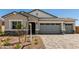 Charming single-Gathering home showcasing a stone-accented facade, two-car garage, and landscaped front yard at 12029 W Marguerite Ave, Avondale, AZ 85323