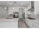 Bright modern kitchen featuring stainless steel appliances and a large quartz countertop island at 12029 W Marguerite Ave, Avondale, AZ 85323
