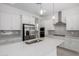 Bright, modern kitchen with stainless steel appliances, quartz countertops, and stylish pendant lighting at 12029 W Marguerite Ave, Avondale, AZ 85323