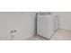 Laundry room with modern, white front load washer and dryer, plus tile floors at 12029 W Marguerite Ave, Avondale, AZ 85323