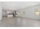 Spacious open-concept living area, featuring white walls, tile flooring, and natural lighting at 12029 W Marguerite Ave, Avondale, AZ 85323