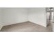 Clean bedroom featuring neutral walls, light wood-look flooring, and an ensuite bathroom at 12123 W Bell Rd # 241, Surprise, AZ 85378