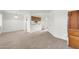 Open-concept living area with wood-look floors flowing into dining space and access to the bathroom at 12123 W Bell Rd # 241, Surprise, AZ 85378