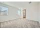 Spacious bedroom with neutral carpet and natural light from two windows at 15065 W Hackamore Dr, Surprise, AZ 85387
