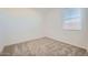 Neutral carpeted bedroom with a view of a large window at 15065 W Hackamore Dr, Surprise, AZ 85387