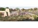 Community entrance sign showcasing the meticulously maintained landscaping and manicured grounds surrounding the development at 15065 W Hackamore Dr, Surprise, AZ 85387